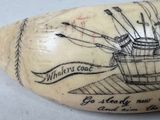 an elephant tooth with a drawing of a boat on it