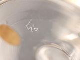 a close up of a glass of water with a yellow dot on it