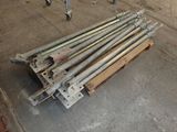 a pile of metal rods on a pallet in a garage