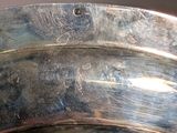 a close up of a silver bowl on a table