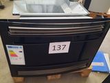 a black oven with a number on it in a store