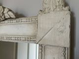a mirror that is hanging on the wall in the room