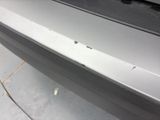 a close up of a car door handle with holes in it