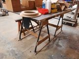 a table with a bowl on top of it in the middle of a room