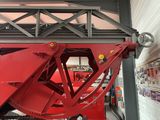 a large red crane that is in a building