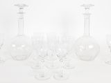 a group of wine glasses and a decanter on a table