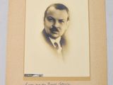 an old photo of a man in a suit and tie with a handwritten note