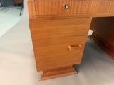 a wooden desk with a drawer on top of it