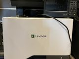 the printer is sitting on the counter in front of the microwave