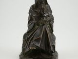 an image of a statue of a woman sitting on a chair