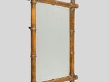 an image of a mirror with a wooden frame on a wall
