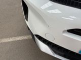 a close up of a car ' s front bumper with a sticker on it