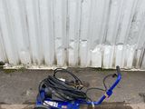 a small blue scooter sitting on the side of the road