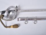a metal pipe clamp with a rope around it and a pair of scissors
