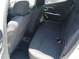the back seats of a white car with a black seat belt