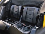 two black seats in the back of a yellow car