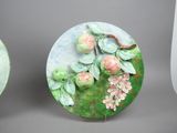two plates with flowers and leaves painted on them