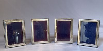 three silver picture frames are lined up against a white background