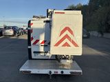 a white truck with a red arrow on the back