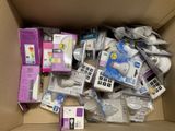 a cardboard box filled with electronic devices and other items