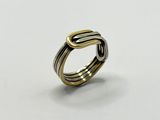 a gold and silver ring on a white surface
