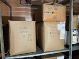 many boxes on a metal shelf in a room