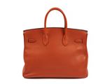 a brown leather tote bag on a white background
