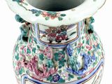 a vase with a floral design on it on a white surface