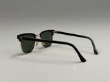 a pair of black and gold sunglasses on a white surface