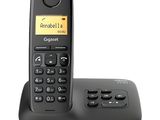 an image of a black corded phone with a yellow button