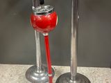 two metal candles that are sitting on a counter