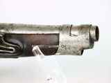 an old gun that is on display on a clear stand