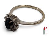 an image of a diamond ring with a black stone in it