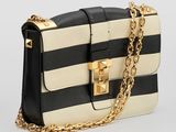 a black and white striped bag with a gold chain strap
