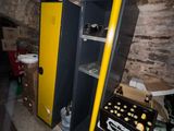 a yellow and black locker in a room with a brick wall
