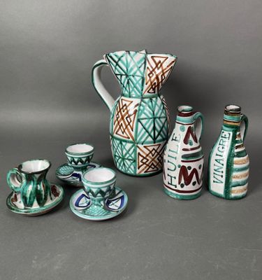 many different types of vases and cups on the table