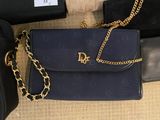 a black purse and a black purse with a gold chain on it