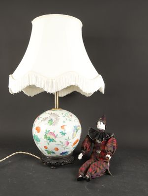 an image of a lamp with a figurine sitting next to it