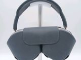 a gray purse that is on a stand on a white surface