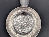 an image of a silver bowl with a spoon in it