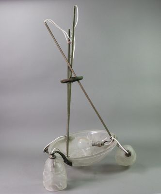 a glass bowl with a handle and a pair of crutches on it