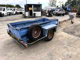 a blue trailer that is sitting in the dirt
