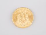 an image of a close up of a gold coin on a white surface