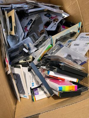 a cardboard box filled with lots of papers and pens