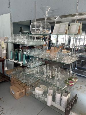 many glasses on the shelves in the room