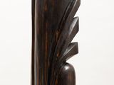 an image of a wooden sculpture on a white pedestal