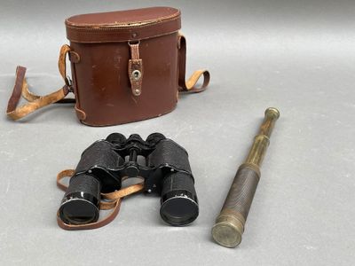 two binoculars and a pair of binoculars on a table
