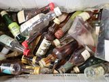 many bottles of alcohol in a box on the floor