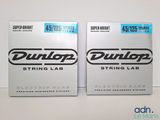 two boxes of dunlop strings are sitting on a table
