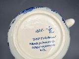 an image of a blue and white cup with writing on it